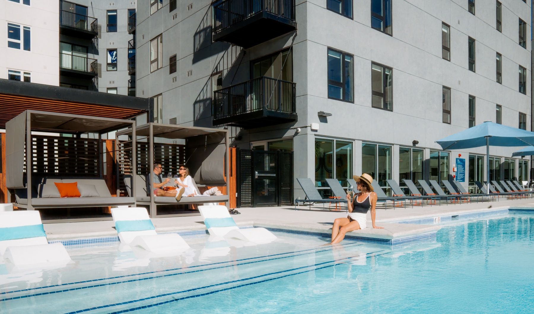 people sitting around pool at Kalaco apartments people sitting around pool at Kalaco apartments